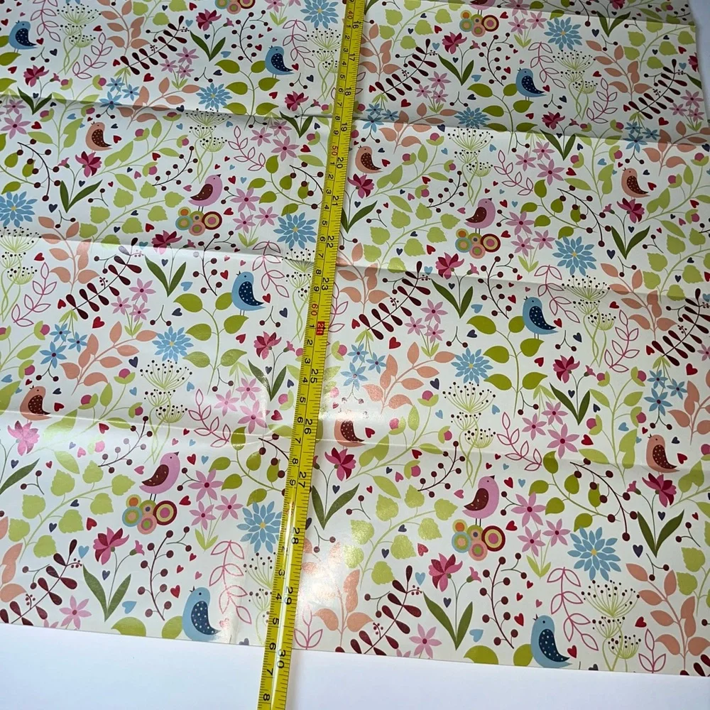 NWOT 15 sheets of flowered wrapping paper. Most sheets are 20” x 30”, at a min
